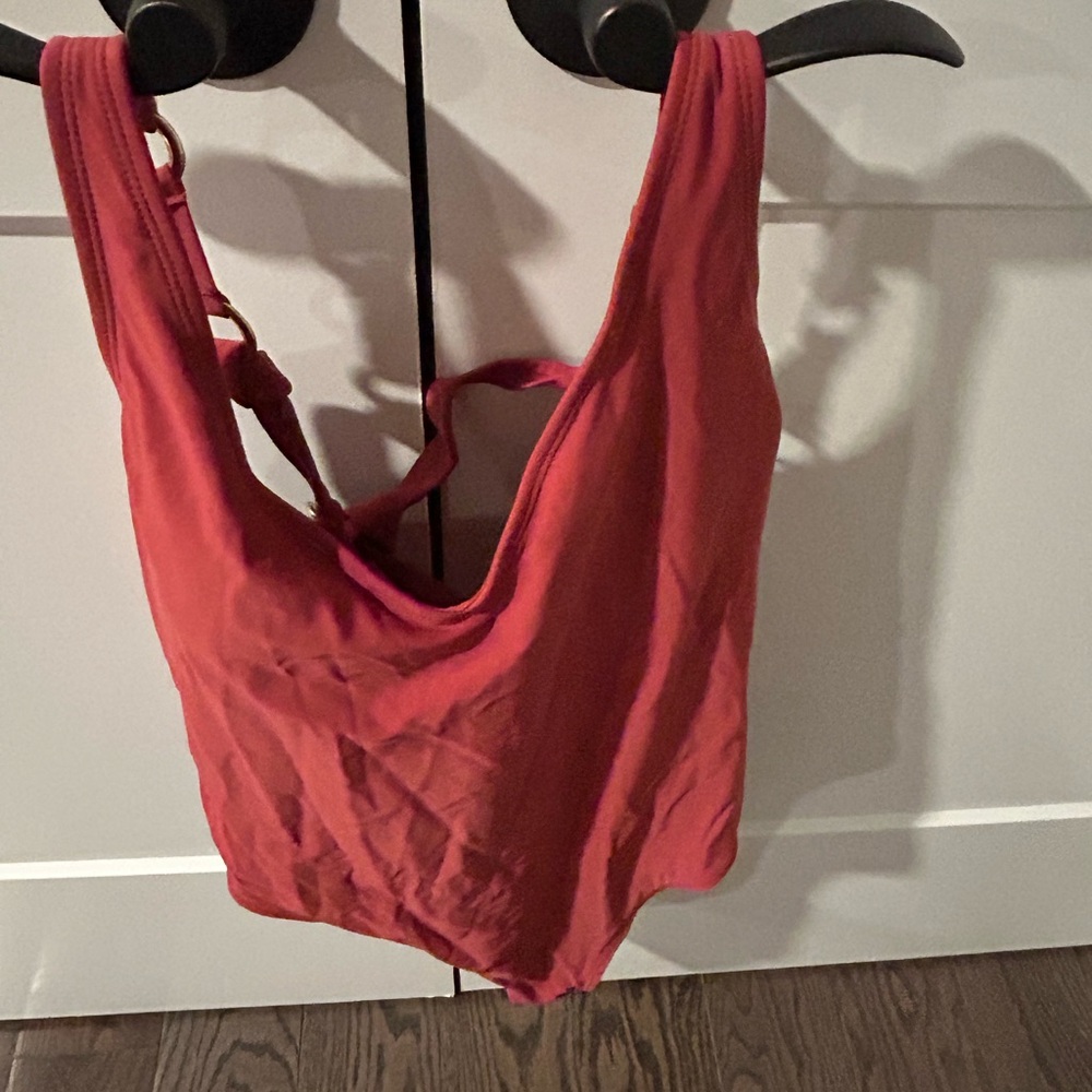 Light brownish/red, gorgeous detail on the back. Slight V neckline.